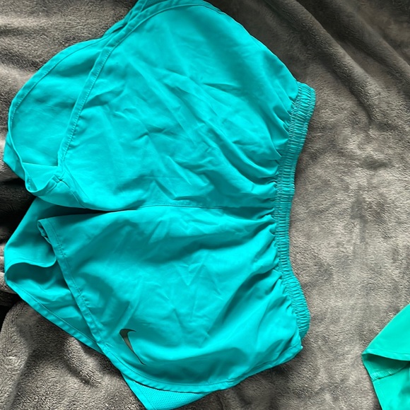 Teal nike shorts with pocket in back, small stain on right side - Picture 1 of 4